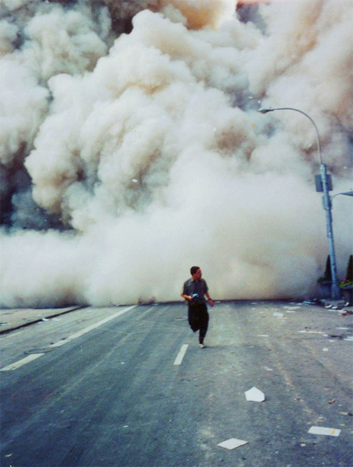 A Lone Man Runs Down Broadway As A Smoke And Dust Cloud Comes Up The Street From The Collapsing World Trade Center Buildings In New York September 11, 2001 A Lone Man Runs Down Broadway As A Smoke And Dust Cloud Comes Up The Street From The Collapsing World Trade Center Buildings In New York September 11, 2001