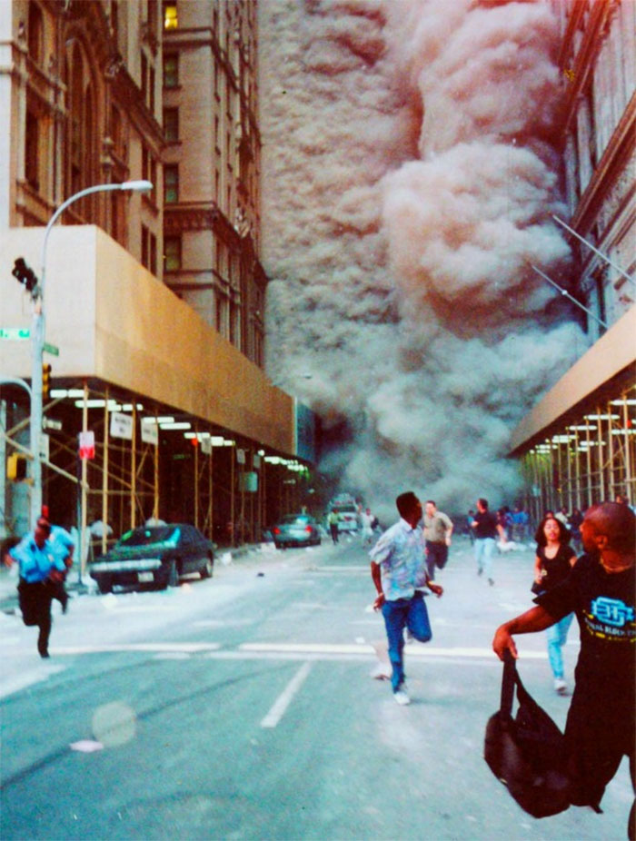 People Run Down Broadway As A Smoke And Dust Cloud Comes Up The Street From The Collapsing World Trade Center Buildings In New York People Run Down Broadway As A Smoke And Dust Cloud Comes Up The Street From The Collapsing World Trade Center Buildings In New York